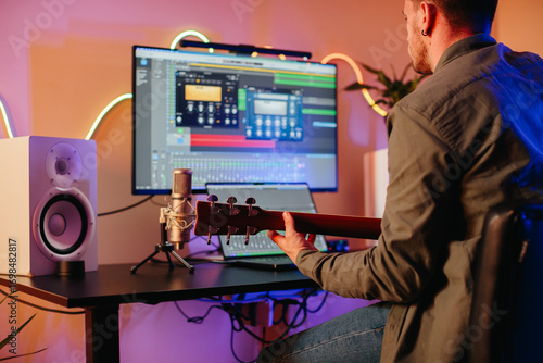 Canvas Print Musician composing music at home recording studio playing guitar