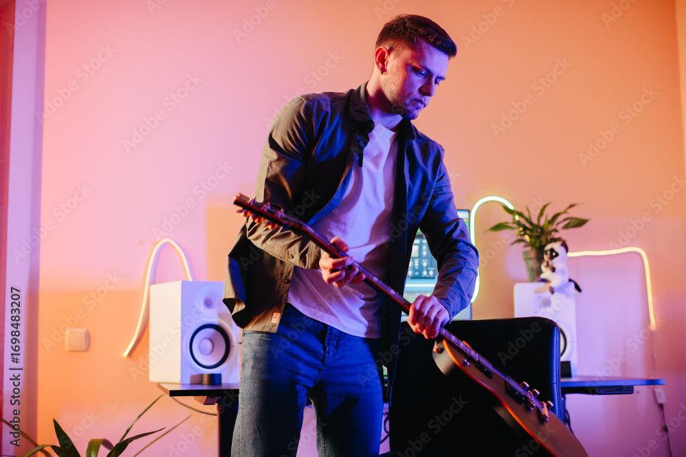 Obraz premium Musician composing new music playing electric guitar at home studio