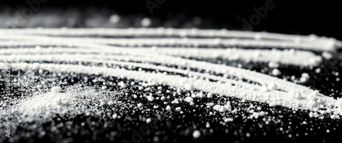 Close-up of several lines of cocaine powder on a stark black background,  illegal drug,  texture