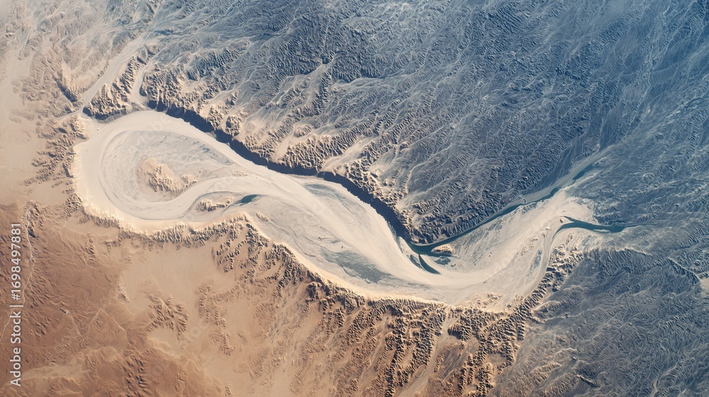 Fototapeta premium A stunning aerial view from space of a massive, sinuous sand dune resembling a slug, dramatically cutting through a textured floodplain landscape.