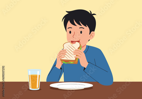 Young boy enjoying a delicious sandwich and a refreshing glass of juice at the table