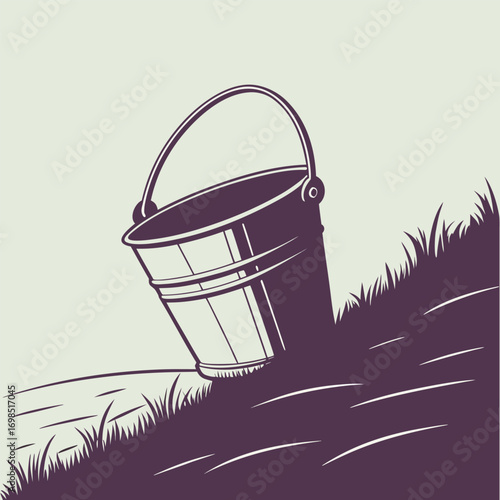 a metal bucket resting on grassy hillside with handle