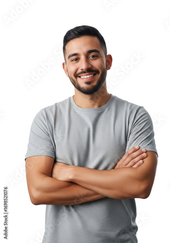 Young adult hispanic man (25-30) with short dark hair, beard, grey t-shirt, arms crossed, smiling confidently in a transparent studio, professional studio portrait concept