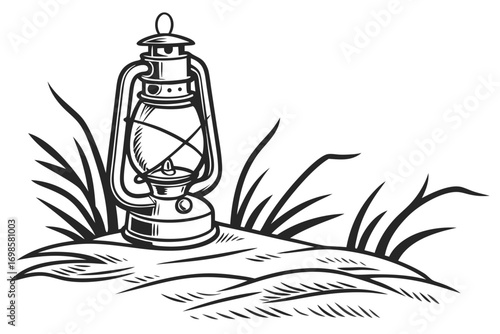 Vintage oil lantern standing in tall grass on a hillside