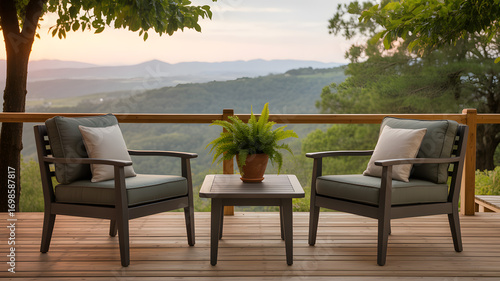 Wallpaper Mural Serene Balcony with Mountain View: A cozy outdoor seating area on a balcony invites relaxation with its comfortable armchairs and a small table, all overlooking a stunning mountain panorama. Torontodigital.ca