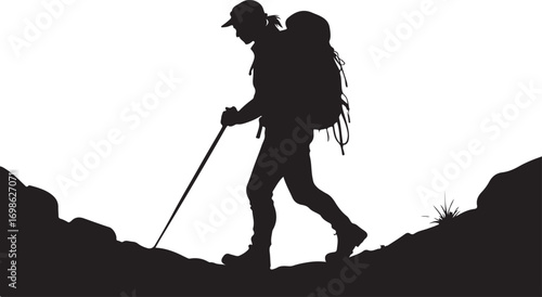Silhouette of a hiker with backpack and trekking pole walking on rocky terrain