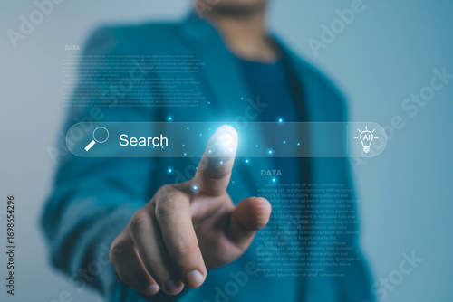 Businessman using AI-powered search engine interface, symbolizing smart search, SEO, data analysis, and artificial intelligence digital transformation and online business growth website, information,