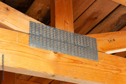 Timber roof trusses with metal connector plates, close‑up