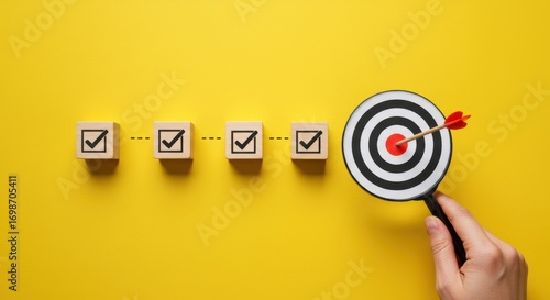 Achieving goals with strategic planning and focus represented by a bullseye target and checked boxes on yellow background
