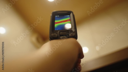 Hand holding thermal imager checking heat distribution