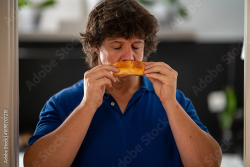 Man Savoring the Aroma of Fresh Milk Bread Roll