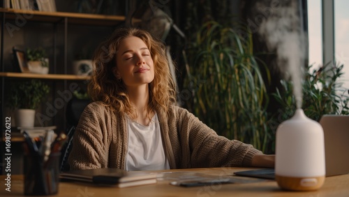 Professional Relaxing: Busy Person Closing Eyes with an Aromatherapy Diffuser at a Home Office Desk.