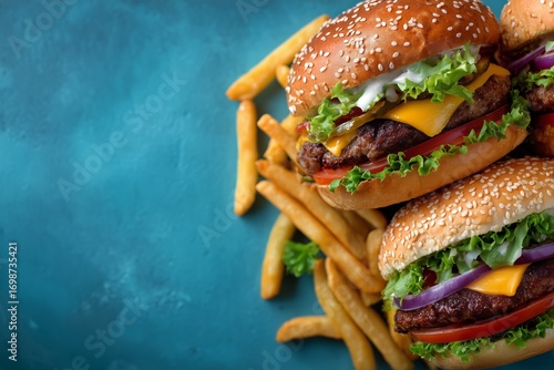 Delicious Burgers With Fresh Ingredients and Crispy Fries on a Blue Background.