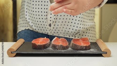 Female hands preparing the trout fish for cooking at home kitchen. Concepts of healthy eating and seafood