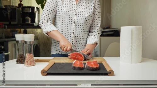 Female hands preparing the trout fish for cooking at home kitchen. Concepts of healthy eating and seafood