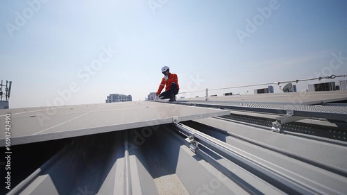 Solar panel technicians perform inspection on rooftop during bright day