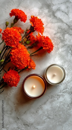 Bright Marigold Flowers Beside a Scented Candle on a Marble Surface During Da...