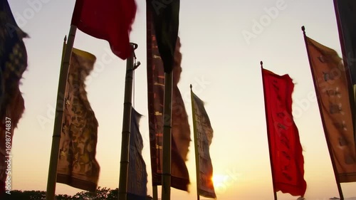 Colorful flags waving in the wind at sunset