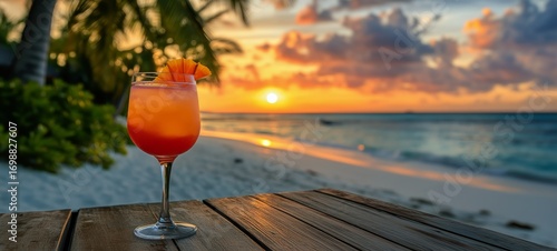 Tropical Cocktail at Sunset Overlooking a Beautiful Beach in Maldives