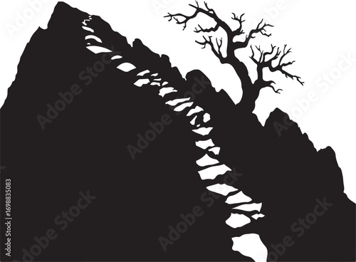Silhouette of a rocky mountain path with a bare tree