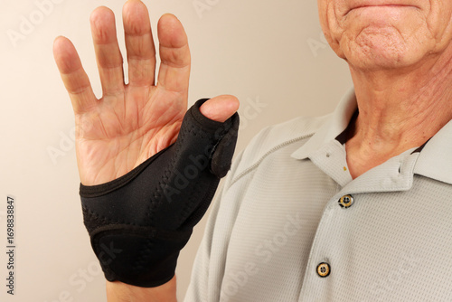 Man wearing a Wrist and Thumb support Brace for Arthritis and Thumb pain