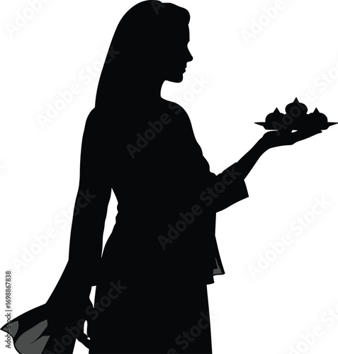 Silhouette of woman holding plate with traditional sweets or offerings, ideal for festive celebrations, rituals, cultural events, or Diwali.