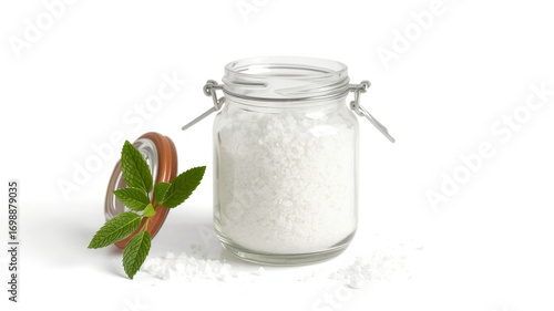 Baking soda in glass jar with mint leaves for natural cleaning and diy beauty recipes on white background