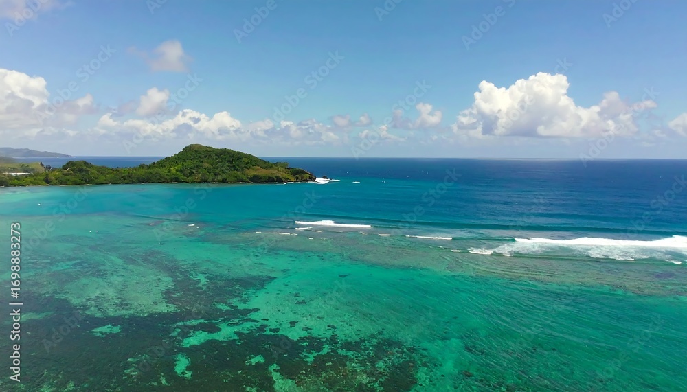 Fototapeta premium Turquoise ocean meets lush island. Aerial view of a tropical coastline with a vibrant coral reef and small island
