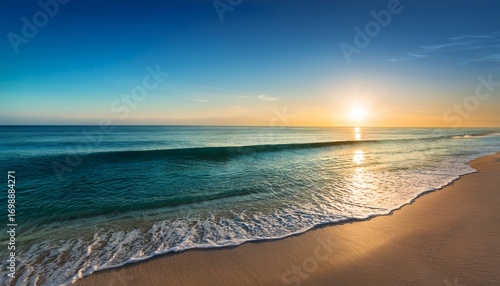 a peaceful beach scene at sunset where the sun is rays stretch across the water turning the sea into a canvas of warm colors the beach is empty with only a few footprints left behind in the sand