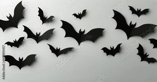 Black Paper Bats Decorate a White Wall for a Halloween Party in October