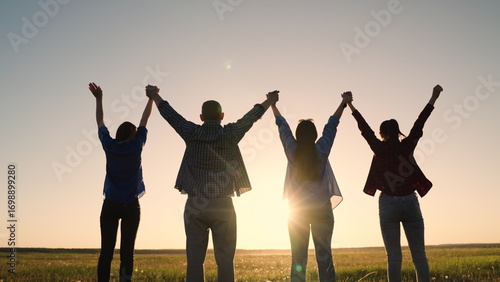 Teamwork of people raising their hands to sky, family business team concept. Group of people holding hands raise their hands to sky, prayer of man of woman. Business people, partners, trust concept
