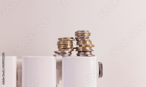 Cost of living crisis. Money on a home radiator heater. Rising cost of energy and bills