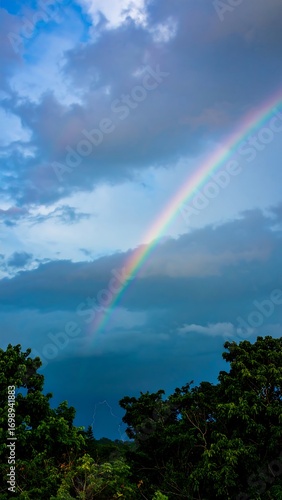 Rainbow arches over a cloudy sky