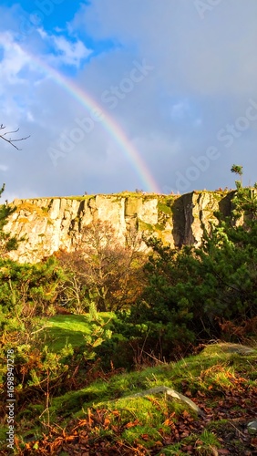 Rainbow over a rocky cliff face