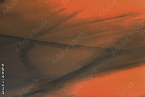 Traces airplane air trail jet line stripe sunset orange sky background