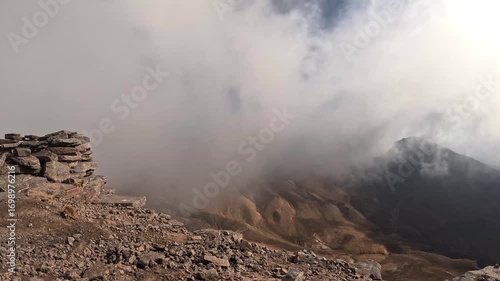 Beautiful time lapse in the mountains with dramatic clouds and fog.