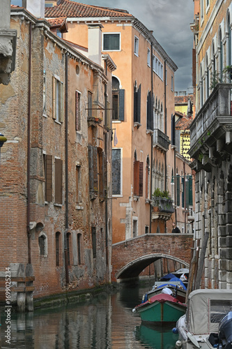 Alone on a bridge over a Venetian canal