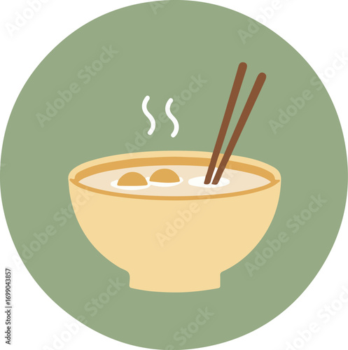 Close-up of creamy soup in a bowl with chopsticks on a green background
