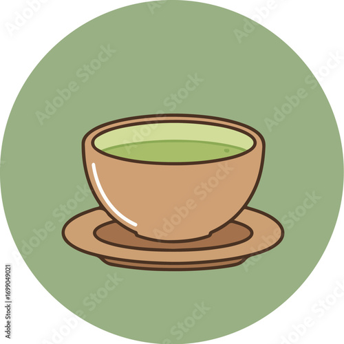 Light brown ceramic teacup with vibrant green tea on matching saucer against green background