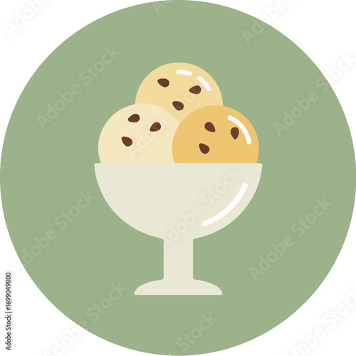 Close-up of three scoops of light yellow ice cream with dark chocolate chips in a white stemmed dish on a green background