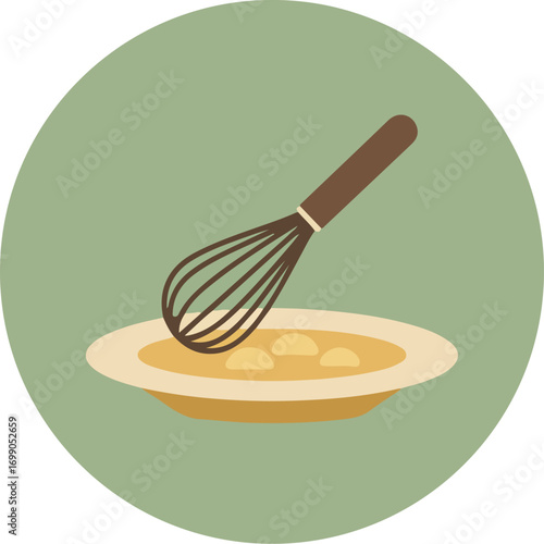 Close-up of a white ceramic bowl with egg mixture and a whisk on a green background