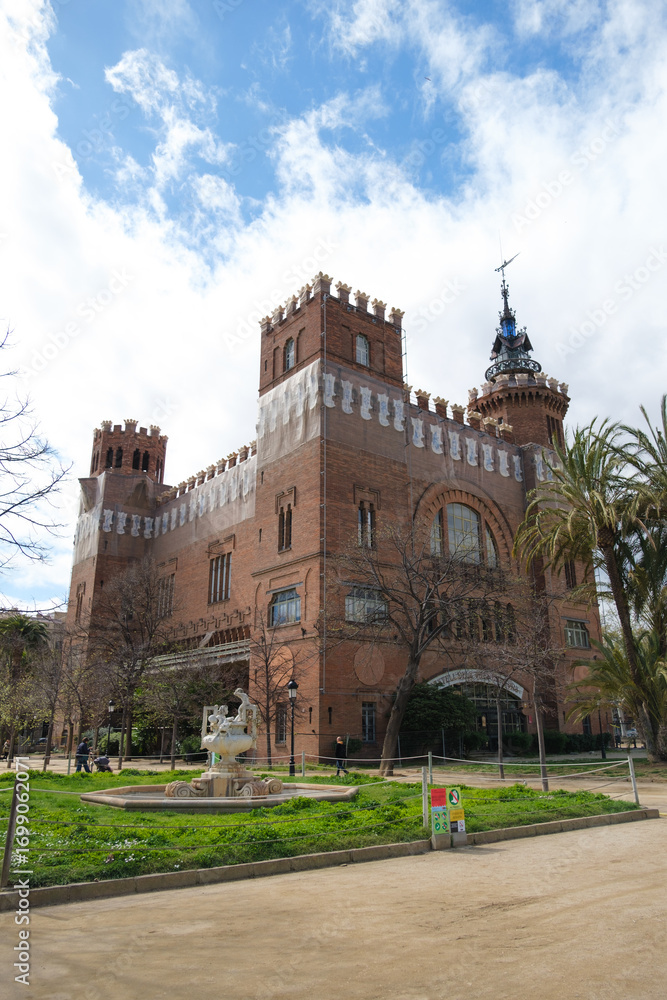 Fototapeta premium A stunning view of a historic building in Barcelona, Spain, captured on March 26, 2024. The image showcases the intricate architectural details of the structure, set against a backdrop of a partly ...
