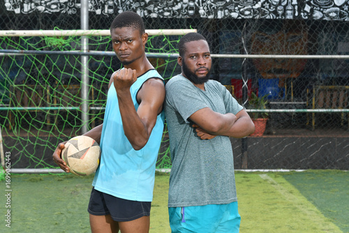 two african Soccer players having fun after friendly match on soccer field