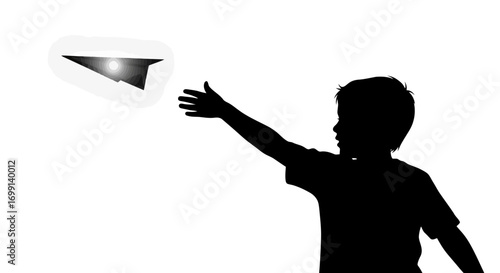 Silhouette of a child throwing a paper airplane into the sky