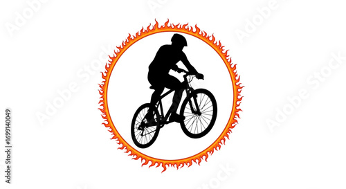 Silhouette of a cyclist jumping through a ring of fire