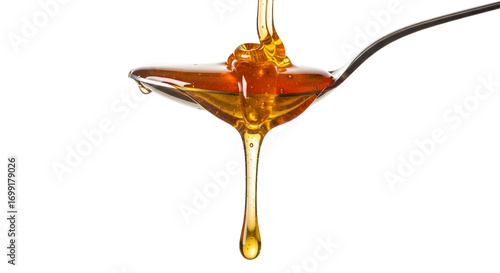 Honey dripping from spoon isolated on white background