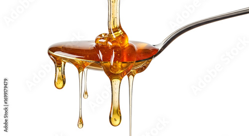 Honey dripping from spoon isolated on white background