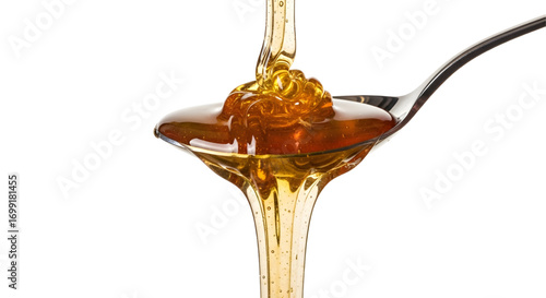 Honey dripping from spoon isolated on white background
