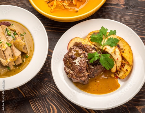 Gourmet steak with apple slices and a hearty stew, perfect for a delicious AIzaSyBuSysZMM0Ghi_0oFmr1OmbUEuZk__VpvU meal