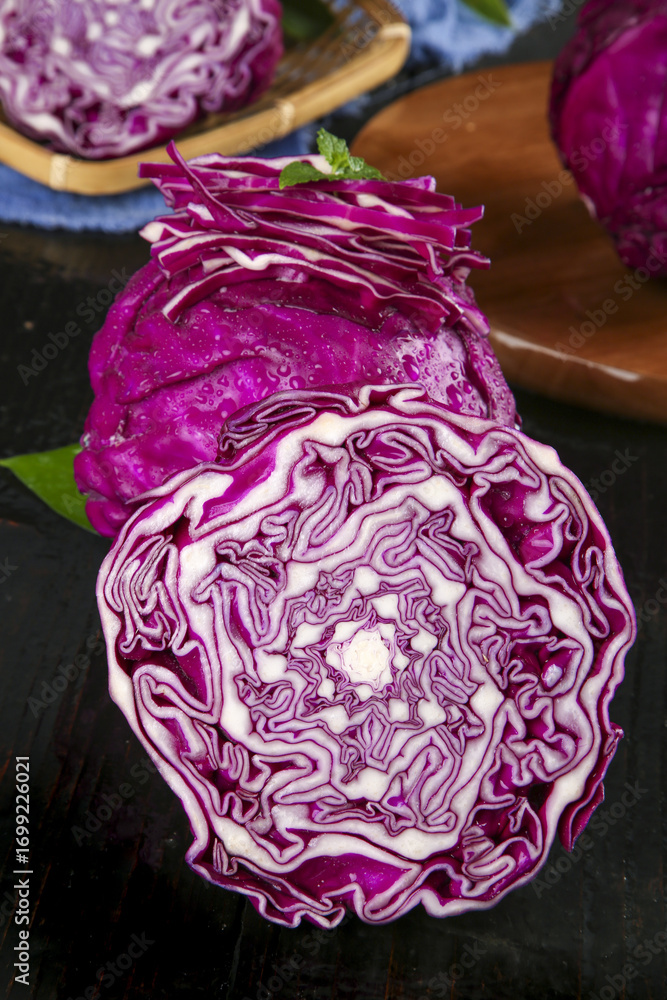 Fototapeta premium Fresh Purple Cabbage Cross Section with Feathery Layers and Natural Patterns on Wooden Background